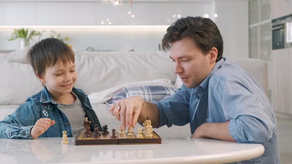 Father and Son Playing Chess alt