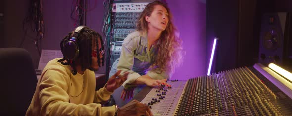 Multiethnic Colleagues Recording Music in Studio alt