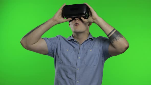 Man Using VR App Helmet To Play Simulation Game, Drawing. Guy Watching Virtual Reality 3d Video alt