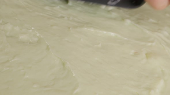 Shiny cream topping spreading manually on baked cake surface 4K 2160p 30fps UltraHD video - Milk and alt