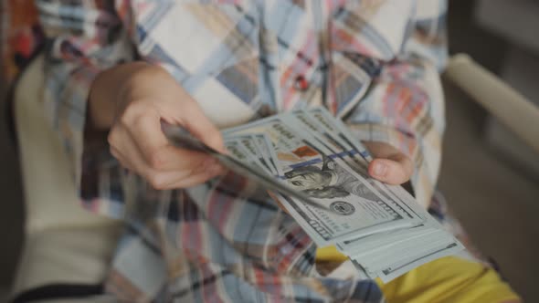 A Teenage Girl Counts Hundreddollar Bills Closeup