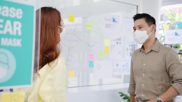 Asia greeting with elbow bump and wear medical face mask for social distancing in new normal. alt