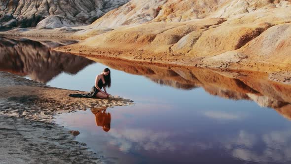 Beautiful woman posing on other-worldly hilly landscape