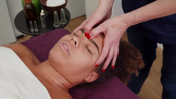 Skilled Therapist Pressing Acupressure Facial Rejuvenation Points alt