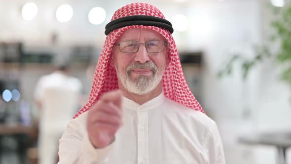 Senior Old Arab Businessman with Pointing and Inviting alt