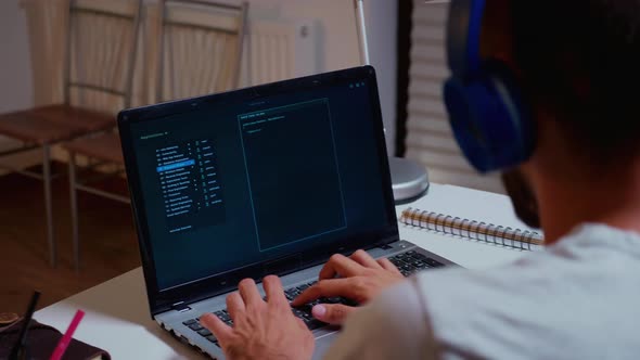 Hacker Typing on the Computer at Night alt