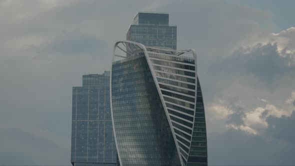 the Facade of a Modern Business Center with a Beautiful Design Against the Backdrop of Cloudy alt