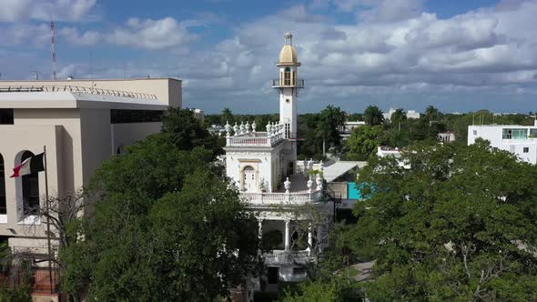 Aerial descent with camera pitch up of the el Minaret mansion on the Paseo de Montejo in Merida, Yuc alt