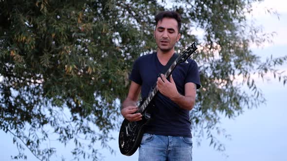 Playing Guitar Singing alt