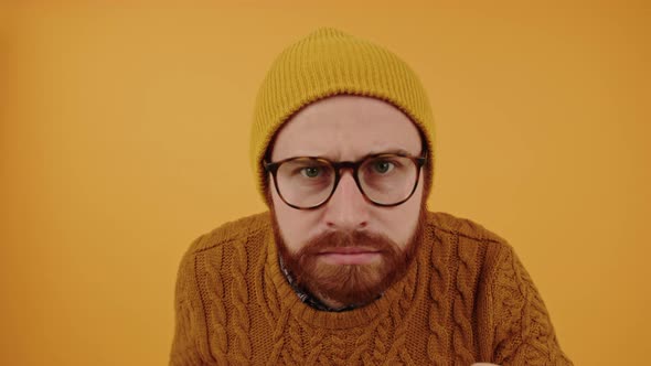 Middleaged Bearded Hipster Man Knocking at the Screen and Suspiciously Looking Inside Yellow alt