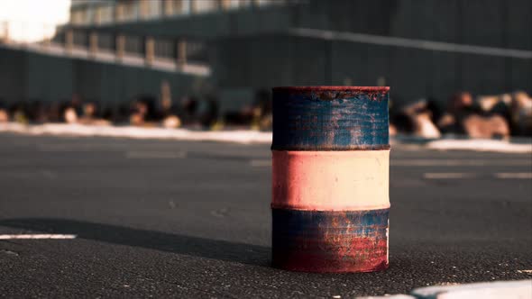Old and Rusty Metal Barrel on Parking alt