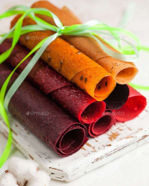 assorted apple pastilles in rolls on a light background close-up