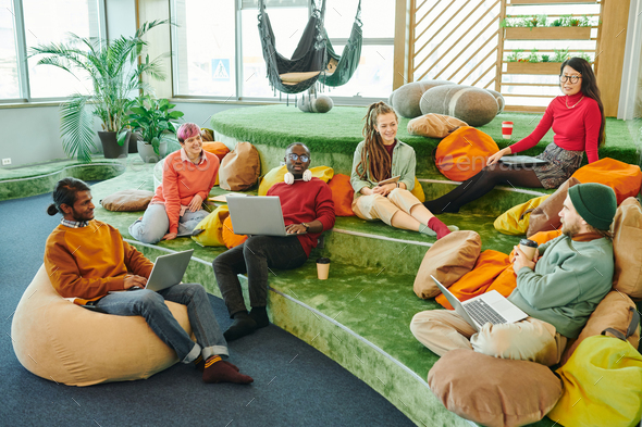 Happy young intercultural managers discussing new ideas at start-up meeting - Stock Photo - Images