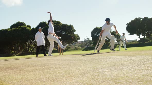 Bowler delivering ball during cricket match alt
