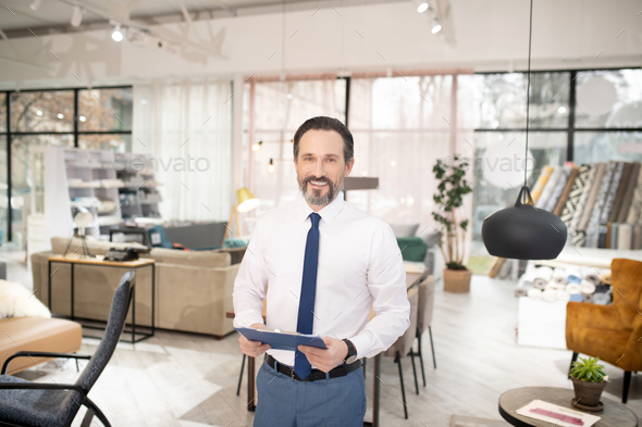 Furniture designer in tie and white shirt feeling positive