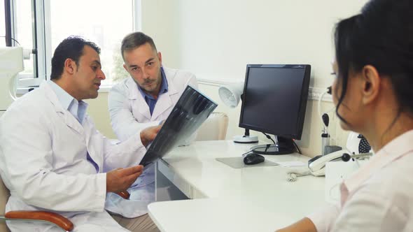 Doctors Examine the X-Ray While Sitting in the Office
