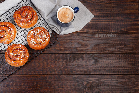 Traditional Swedish cinnamon buns Kanelbulle with cup of coffee or cappuccino - Stock Photo - Images