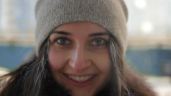 Slow Motion Portrait of Young Happy Woman in a Winter Cityscape.