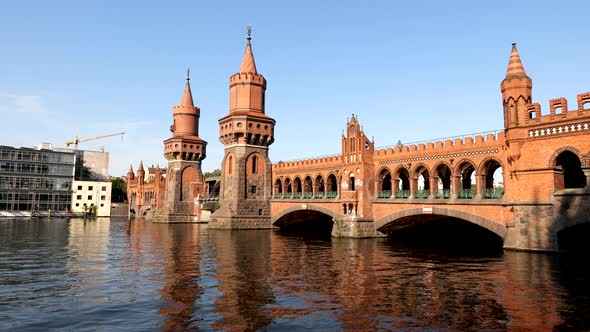Oberbaum Bridge (Oberbaumbrucke) over River Spree at sunset in Berlin, Germany, North German Brick G alt