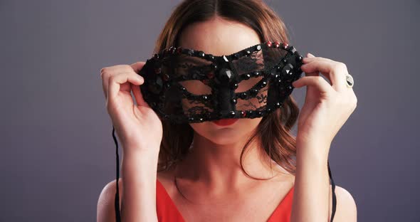 Portrait of beautiful woman wearing masquerade mask 4k alt