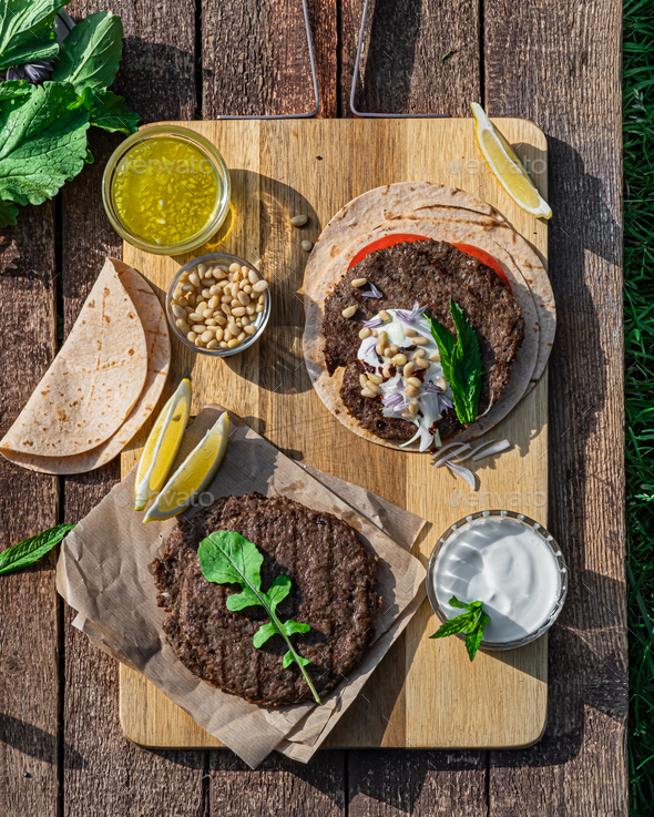 Spicy lamb kebab patties served with mint dip, crunchy salad, pitta bread and raw red onions