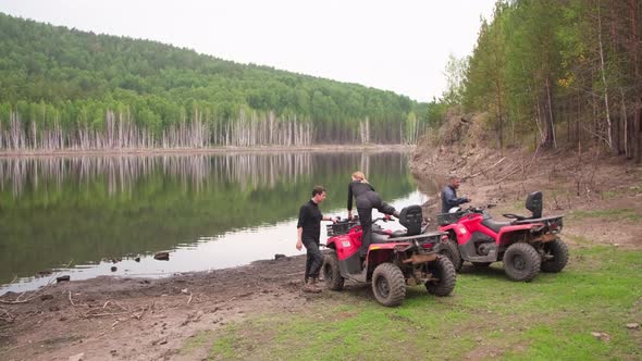 People Getting on Quad Bikes in Forest alt