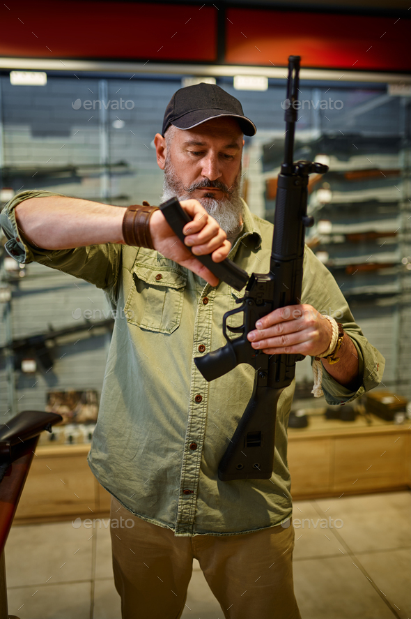 Man loads automatic rifle in gun store