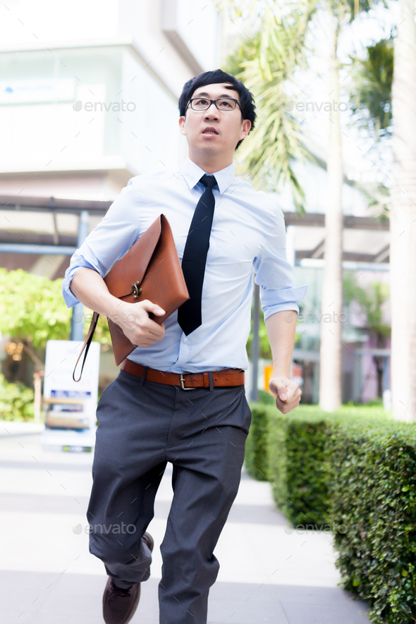 Young Business Asian exhausted man running late for work