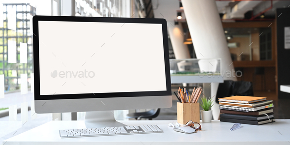 Photo of white blank screen computer monitor on office desk. - Stock Photo - Images