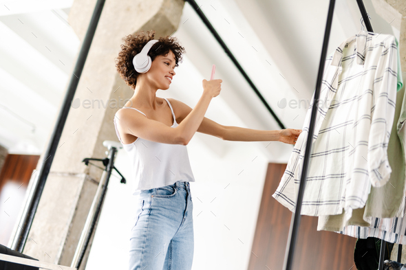 Young woman chooses clothes in the wardrobe closet - Stock Photo - Images