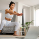 Sporty beautiful woman exercising at home to stay fit Stock Photo by nd3000