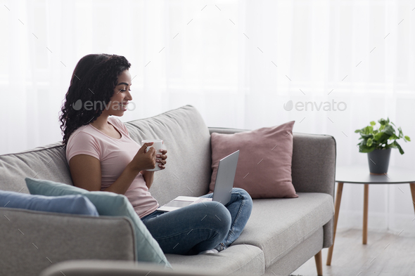 Relax with favorite drink and social networks, creating idea for work online, enjoy tasty tea - Stock Photo - Images