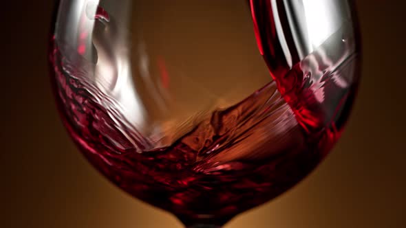 Super Slow Motion Detail Shot of Pouring Red Wine on Luxury Gradient Background at 1000Fps. alt