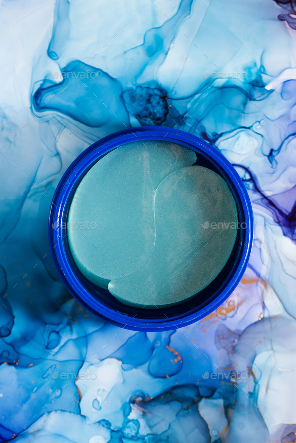 Anti-aging patches in blue packaging on a blue background. Korean cosmetics for skin care.