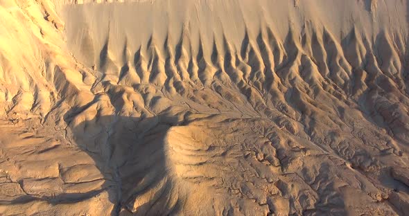 Aerial footage at the desert viewing a beautiful mountain patterns during sunrise