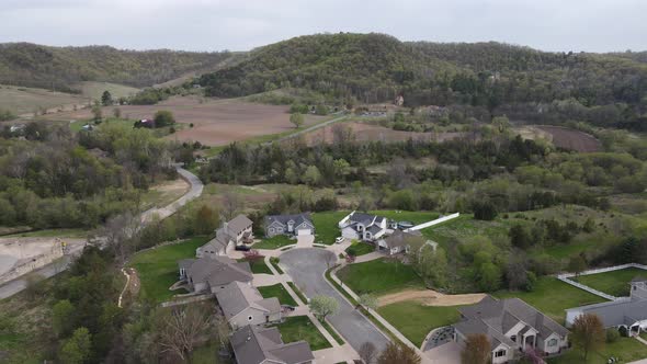 Residential community nestled in a valley in midwest Wisconsin in autumn. Mountains in horizon.