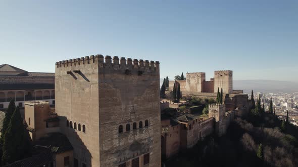 Drone flying around Comares Tower of Alhambra fortress, Granada in Spain. Aerial orbiting