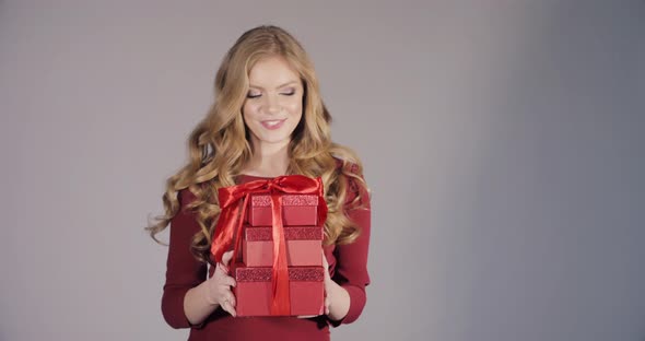 Beautiful Blonde Lady in Bordo Dress Getting Birthday Gifts