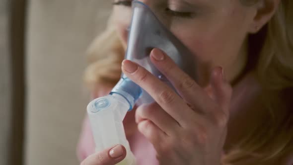 Close Up Sick Female Using Oxygen Mask at Home a 30s Woman Has Labored Breathing Treatment at Home alt