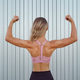 Muscular woman back in pink bra Stock Photo by diignat