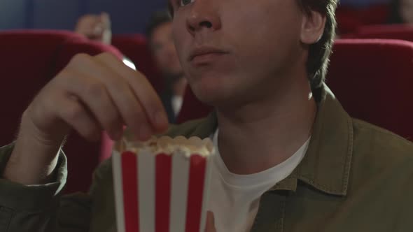 Man Eating Popcorn in Cinema alt