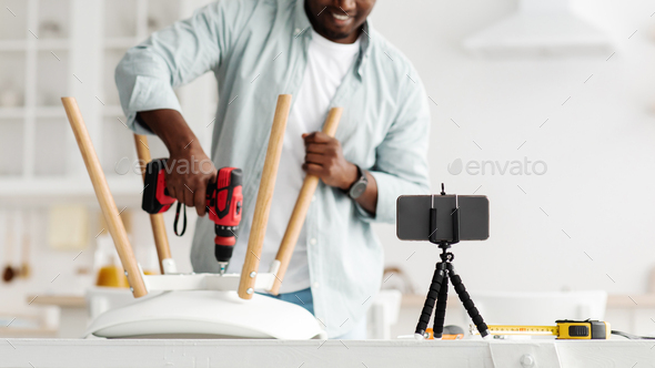 Handyman blogger shooting video instructions for assembling furniture at home with own hands, using