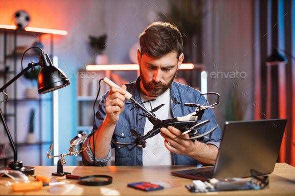 Caucasian Man Using Soldering Iron For Fixing Quadcopter Stock Photo By Sofiiashunkina