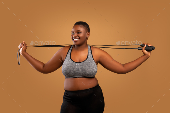 Young Black Chubby Woman Posing With Jumping Rope At Studio Stock Photo by  Prostock-studio