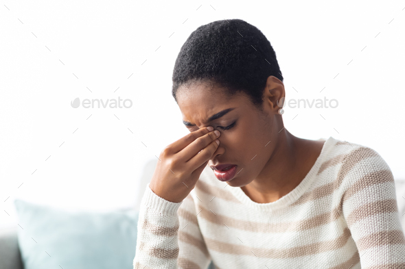Stress Concept. Upset African American Woman Rubbing Nose Bridge, Closeup Shot