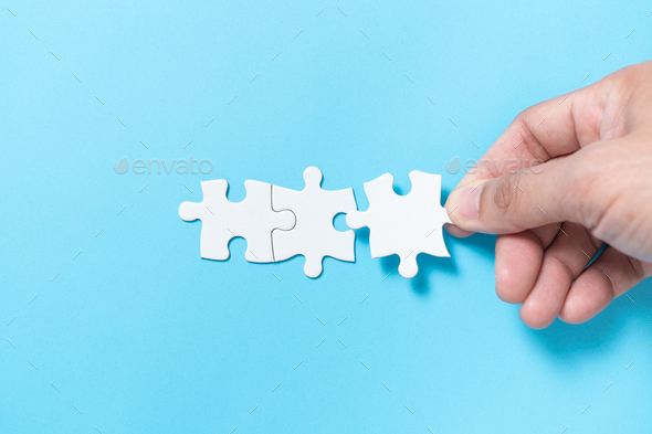 Business merging concept using white jigsaw puzzle - Stock Photo - Images