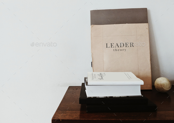 Leader theory book with a baseball on the table - Stock Photo - Images