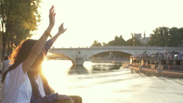 Couple waving hands at sunset in Paris, France