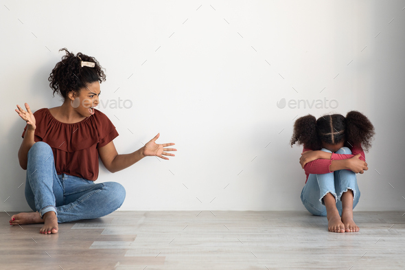Mad black lady shouting at her crying female kid