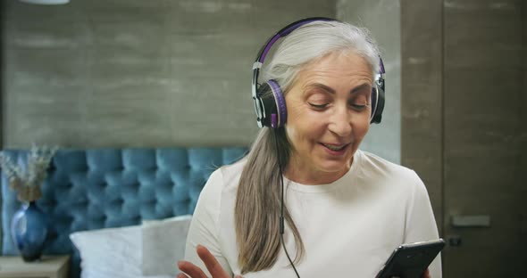 Elderly Woman with Smartphone Music